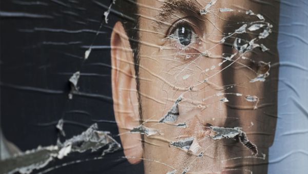 A  picture taken in Paris on May 5, 2017 shows vandalised campaign posters of French presidential election candidate for the En Marche ! movement, Emmanuel Macron - Sputnik International