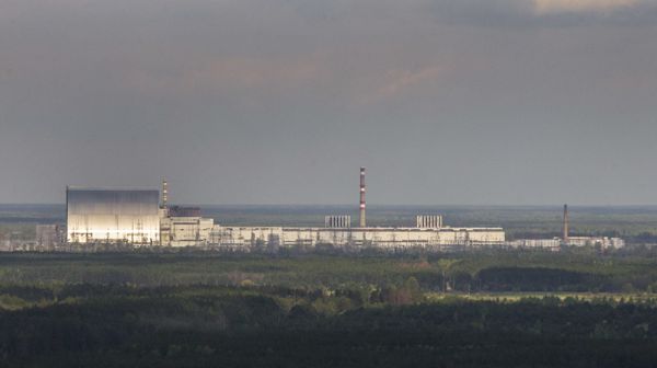 An aerial view of the Chernobyl nuclear power plant and a new shelter, left, installed over the exploded reactor at the Chernobyl nuclear plant, in Chernobyl, Ukraine, Thursday, April 26, 2018. - Sputnik International