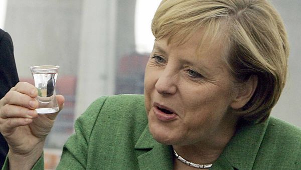 German Chancellor Angela Merkel, drinks the traditional schnaps after she layed a foundation stone for a new lignite power plant near Duesseldorf, western Germany, on Wednesday Aug.23, 2006 - Sputnik International