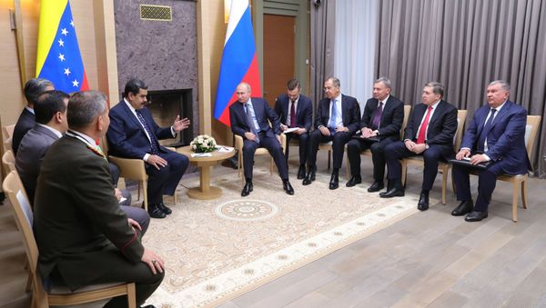 Venezuelan President Nicolas Maduro, background left, and Russian President Vladimir Putin, background center, attend the talks at the Novo-Ogaryovo residence outside Moscow, Russia, Wednesday, Dec. 5, 2018. - Sputnik International