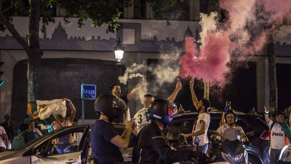Algeria supporters celebrate on the Champs-Elysees in Paris, near the Arc de Triomphe, after Algeria won the Africa Cup of Nations final soccer match against Senegal - Sputnik International