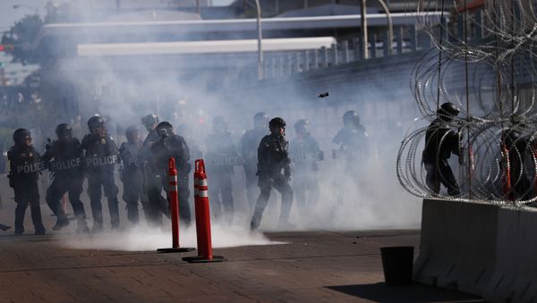 U.S. Customs and Border Protection police conduct a drill using tear gas on International Bridge 1 Las Americas, which connects Laredo, Texas in the U.S. with Nuevo Laredo, Mexico U.S. Customs and Border Protection police conduct a drill using tear gas on International Bridge 1 Las Americas, which connects Laredo, Texas in the U.S. with Nuevo Laredo, Mexico - Sputnik International