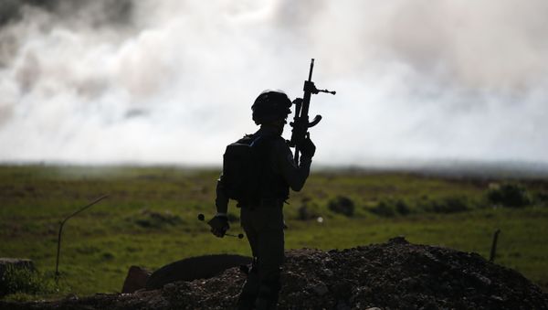 An Israeli soldier pictured during a confrontation with Palestinians in the village of al-Mughayyir, north of Ramallah in the occupied West Bank, on January 25, 2019. - Sputnik International