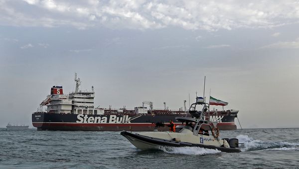 A picture taken on July 21, 2019, shows Iranian Revolutionary Guards patrolling around the British-flagged tanker Stena Impero as it's anchored off the Iranian port city of Bandar Abbas. - Sputnik International