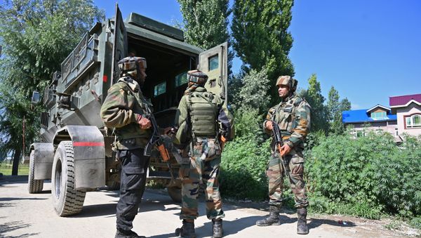 Indian army soldiers stand near the site of a gun battle between a suspected militant and Indian government forces in the Kanipora area of Nowgam in central Kashmir's Budgam district on June 28, 2019 - Sputnik International