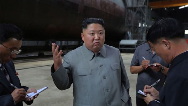 This undated picture released from North Korea's official Korean Central News Agency (KCNA) on July 23, 2019 shows North Korean leader Kim Jong Un (C) inspecting a newly built submarine at an undisclosed location. - Sputnik International