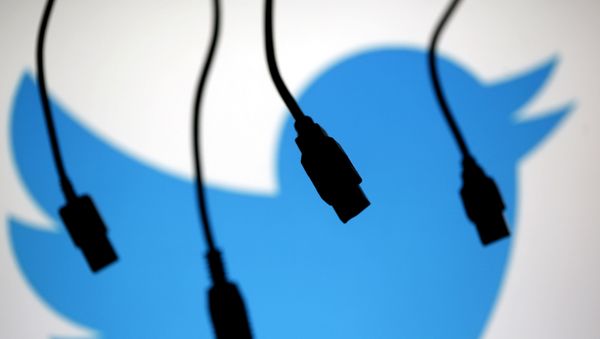 Electronic cables are silhouetted next to the logo of Twitter in this September 23, 2014 illustration photo in Sarajevo - Sputnik International
