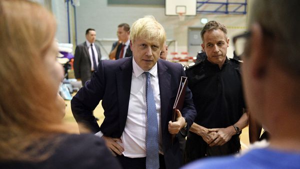 Britain's Prime Minister Boris Johnson meets with rescue crews and local residents during a visit to Chapel-en-le-Frith High School near the village of Whaley Bridge in Derbyshire, England - Sputnik International