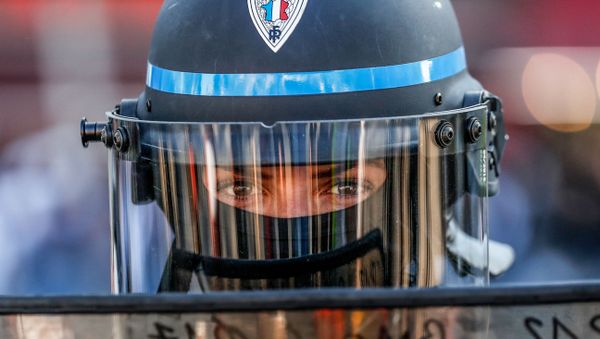A police officer looks on from behind a riot shield during an anti-government demonstration called by the yellow vests (gilets jaunes) movement in Paris on April 20, 2019.  - Sputnik International