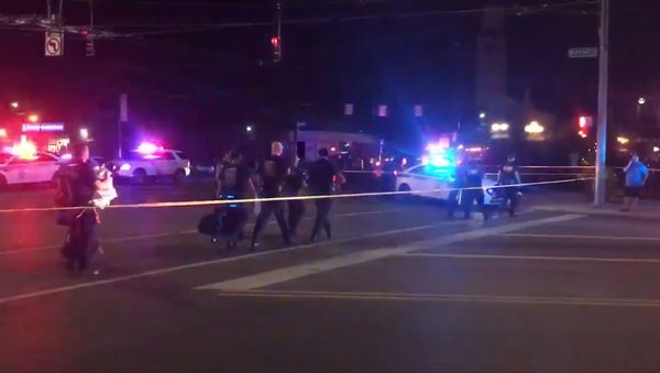 A screenshot taken from the Twitter account of Derek Myers on 4 August 2019, shows police officers following a mass shooting in Dayton, Ohio. A screenshot taken from the Twitter account of Derek Myers on 4 August 2019, shows police officers following a mass shooting in Dayton, Ohio. - Sputnik International
