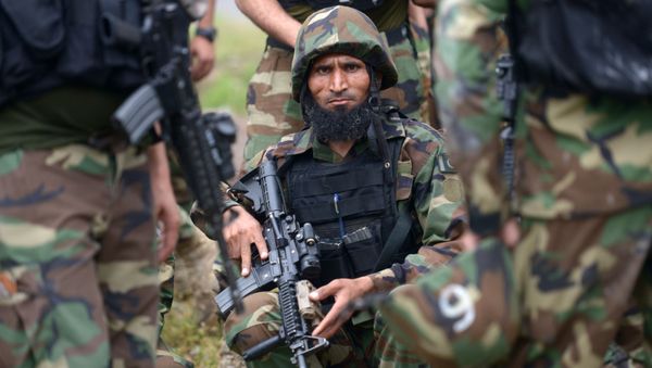 Pakistani soldiers gather beside a demolished hideout of suspected militants during an operation in Peshawar on April 16, 2019 - Sputnik International