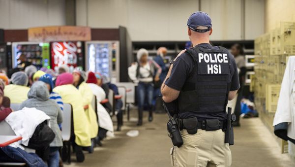 Homeland Security Investigations (HSI) officers from Immigration and Customs Enforcement (ICE) look on after executing search warrants and making some arrests at an agricultural processing facility in Canton Homeland Security Investigations (HSI) officers from Immigration and Customs Enforcement (ICE) look on after executing search warrants and making some arrests at an agricultural processing facility in Canton - Sputnik International