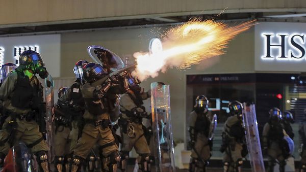 Riot police fire tear gas during the anti-extradition bill protest in Hong Kong, Sunday, Aug. 11, 2019. Police fired tear gas late Sunday afternoon to try to disperse a demonstration in Hong Kong as protesters took over streets in two parts of the Asian financial capital, blocking traffic and setting up another night of likely showdowns with riot police. - Sputnik International