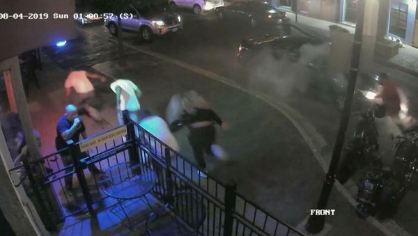 People run during a mass shooting by suspect Connor Betts in a still image from surveillance video released by police in Dayton - Sputnik International