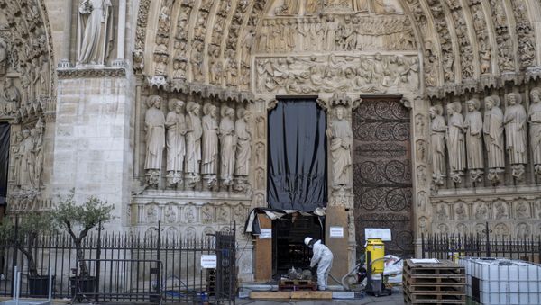 A worker is pictured during preliminary work at the Notre-Dame de Paris Cathedral, in Paris, France July 24, 2019 - Sputnik International