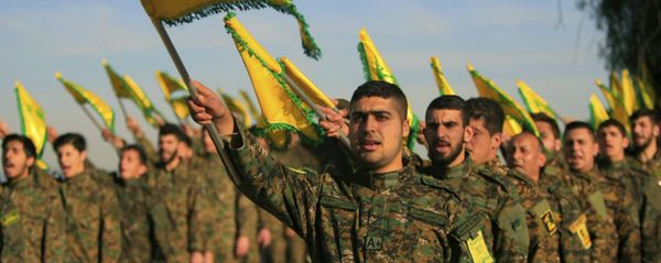 Hezbollah fighters hold flags as they attend the memorial of their slain leader Sheik Abbas al-Mousawi, who was killed by an Israeli airstrike in 1992 - Sputnik International
