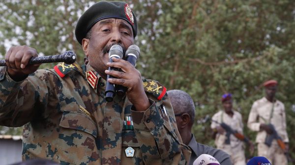 In this June 29, 2019, file photo, Sudanese Gen. Abdel-Fattah Burhan, head of the military council, speaks during a military-backed rally, in Omdurman district, west of Khartoum, Sudan. An African Union envoy says Sudan's ruling military council and the country's pro-democracy movement have reached a power-sharing agreement, including a timetable for a transition to civilian rule. Mohammed el-Hassan Labat said early Friday, July 5, that both sides agreed to form a joint sovereign council that will rule the country for three years or a little more. The sides agreed to five seats for the military and five for civilians with an additional seat going to a civilian with military background. - Sputnik International