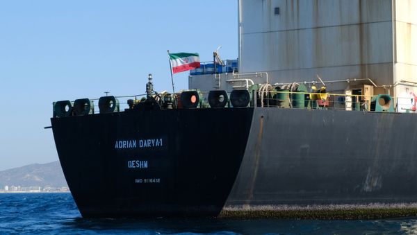 An Iranian flag flutters on board the Adrian Darya oil tanker, formerly known as Grace 1, off the coast of Gibraltar on 18 August 2019. - Gibraltar rejected a US demand to seize the Iranian oil tanker at the centre of a diplomatic dispute as it prepared to leave the British overseas territory after weeks of detention. - Sputnik International