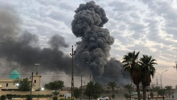 In this Monday, Aug. 12, 2019 file photo, plumes of smoke rise after an explosion at a military base southwest of Baghdad, Iraq. A fact-finding committee appointed by the Iraqi government to investigate a massive munitions depot explosion near the capital Baghdad has concluded that the blast was the result of a drone strike. A copy of the report was obtained by The Associated Press Wednesday, Aug. 21, 2019 - Sputnik International