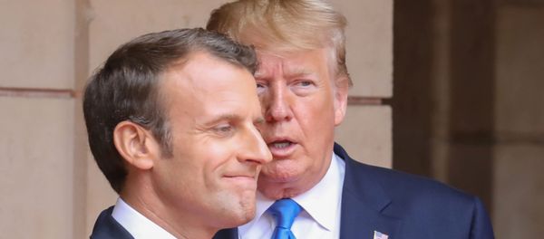 FILE PHOTO: French President Emmanuel Macron speaks with U.S. President Donald Trump on the sidelines of commemorations marking the 75th anniversary of the World War II D-Day landings in Normandy, France,  June 6, 2019 - Sputnik International