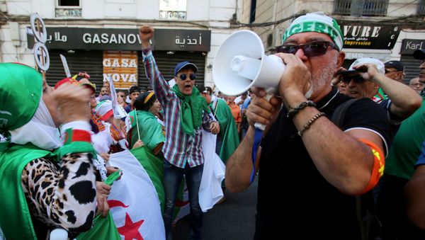 A demonstrator shouts slogans during an anti-government protest in Algiers, Algeria August 23, 2019 - Sputnik International
