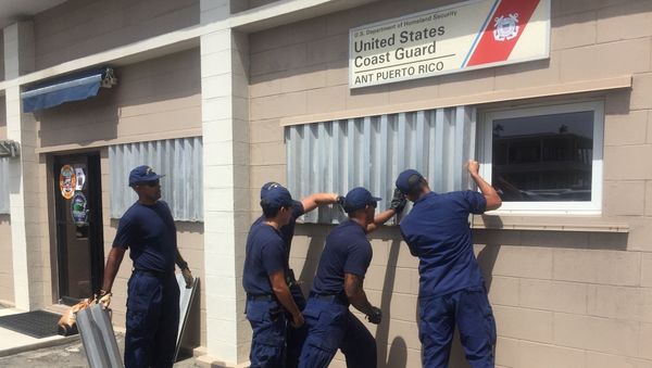 Coast Guard personnel attach hurricane shutters to windows in preparation of Tropical Storm Dorian at Coast Guard Sector San Juan, Puerto Rico August 26, 2019. Picture taken August 26, 2019. U.S. Coast Guard/Ricardo Castrodad/Handout via REUTERS  - Sputnik International