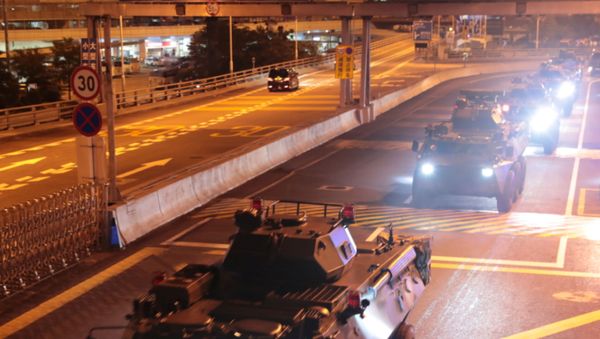 Military vehicles of the Chinese People's Liberation Army (PLA) pass Huanggang Port for a routine troop rotation in Hong Kong Military vehicles of the Chinese People's Liberation Army (PLA) pass Huanggang Port for a routine troop rotation in Hong Kong - Sputnik International