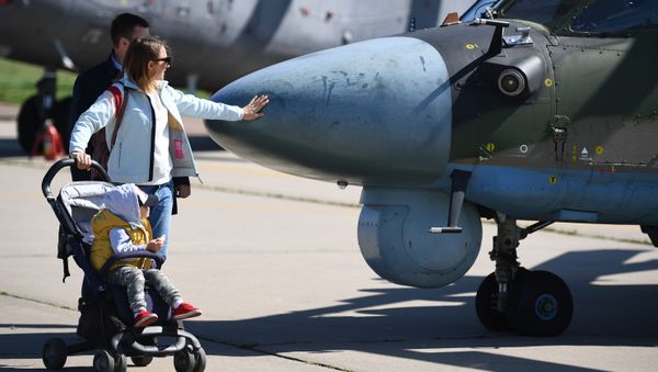 Visitors pass by a Ka-52 Alligator military helicopter on display at the MAKS-2019 International Aviation and Space Show in Zhukovsky, outside Moscow, Russia. - Sputnik International