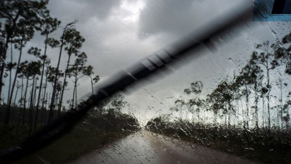 A car returns to the capital under the previous rain before the arrival of Hurricane Dorian in Freeport, Grand Bahama, Bahamas, Sunday Sept. 1, 2019.  - Sputnik International