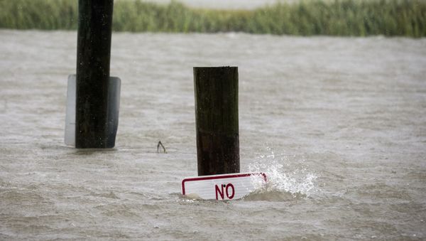 A sign at the Lazaretto Creek boat ramp as is nearly underwater at high tide as Hurricane Dorian makes its way up the east coast, Wednesday, Sept. 4, 2019, toward Tybee Island, Ga. Dorian is forecast to bring storm surge and tropical storm force winds the barrier island. (AP Photo/Stephen B. Morton) - Sputnik International