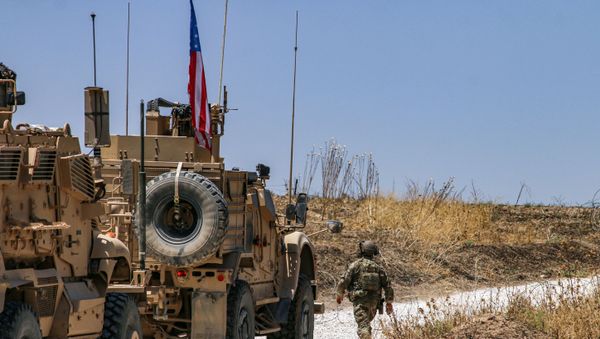 Armoured vehicles of the US-led coalition patrol the city of Ras al-Ain in Syria's Hasakeh province on July 28, 2019. - Sputnik International