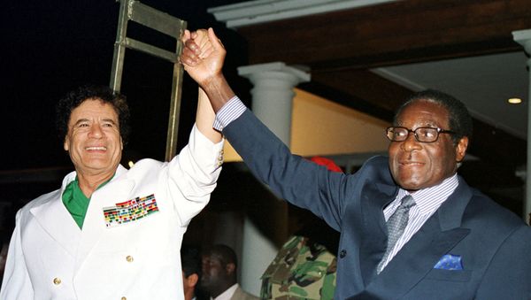 Libyan leader Colonel Muammar Gaddafi (L) and Zimbabwe President Robert Mugabe greet supporters outside State House in Harare, Zimbabwe July 12, 2001 - Sputnik International