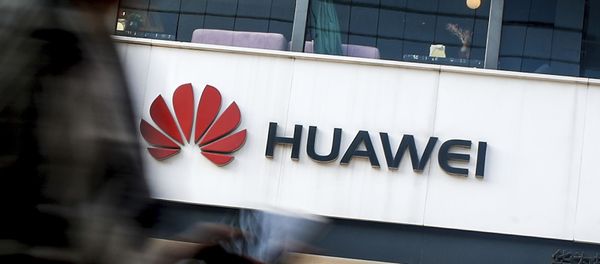 In this July 30, 2019, file photo a woman walks by a Huawei retail store in Beijing. In this July 30, 2019, file photo a woman walks by a Huawei retail store in Beijing. - Sputnik International