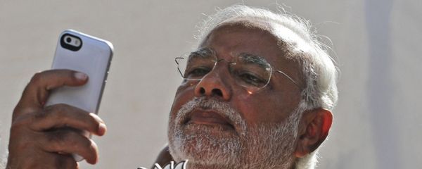 FILE- In this 30 April 2014 file photo, India's main opposition Bharatiya Janata Party's prime ministerial candidate Narendra Modi holds his party's symbol and looks into his phone after casting his vote in Ahmadabad, India. FILE- In this 30 April 2014 file photo, India's main opposition Bharatiya Janata Party's prime ministerial candidate Narendra Modi holds his party's symbol and looks into his phone after casting his vote in Ahmadabad, India. - Sputnik International