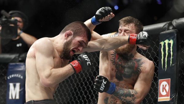 Khabib Nurmagomedov, left, and Conor McGregor throw punches during a lightweight title mixed martial arts bout at UFC 229 in Las Vegas, Saturday, Oct. 6, 2018 - Sputnik International