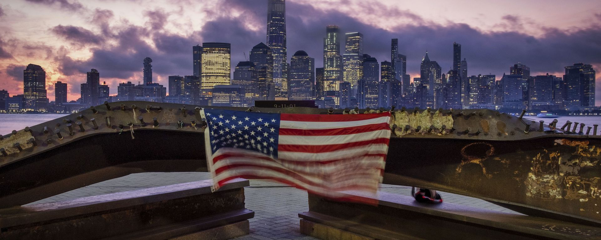 A US flag hanging from a steel girder, damaged in the 11 September 2001 attacks on the World Trade Center, blows in the breeze at a memorial in Jersey City, New Jersey on 11 September 2019. A US flag hanging from a steel girder, damaged in the 11 September 2001 attacks on the World Trade Center, blows in the breeze at a memorial in Jersey City, New Jersey on 11 September 2019. - Sputnik International, 1920, 06.09.2021