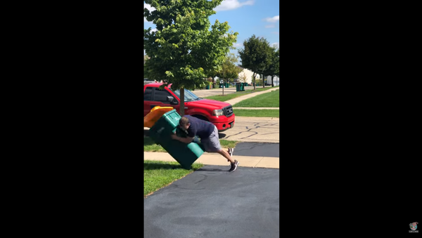 American Football Fan Tackles Garage Can With Opposing Team’s Colors - Sputnik International