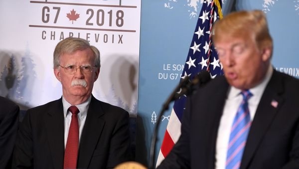 National Security Advisor John Bolton listens as US President Donald Trump speaks to reporters on June 9, 2018, during the G7 Summit - Sputnik International