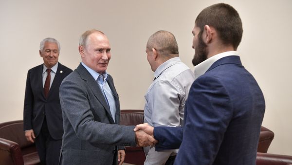 (File photo) Russian President Vladimir Putin and Ultimate Fighting Championship (UFC) lightweight titleholder Khabib Nurmagomedov shake hands during a meeting in Makhachkala, Russia. Head of Dagestan Republic Vladimir Vasilyev is at left. 12.09.2019  - Sputnik International