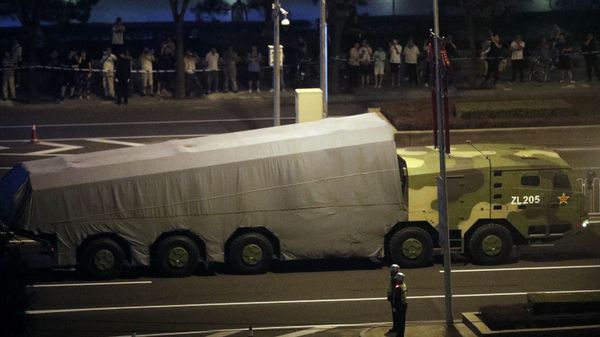 A Chinese military vehicle passes along a street in Beijing, Saturday, Sept. 14, 2019 - Sputnik International