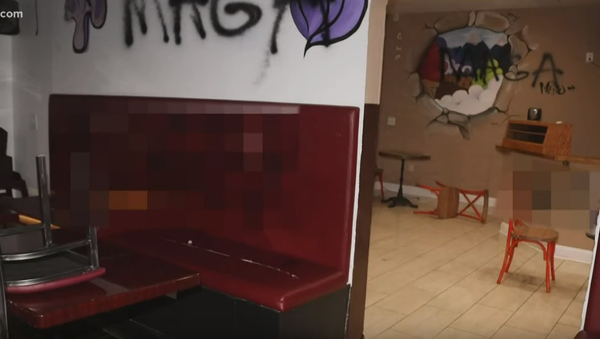 MAGA written on the walls of Edawn Coughman's Lawrenceville Create & Bake Pizza and Coughman’s Creamery. Racial slurs were also written on the wall but are blurred out.  - Sputnik International