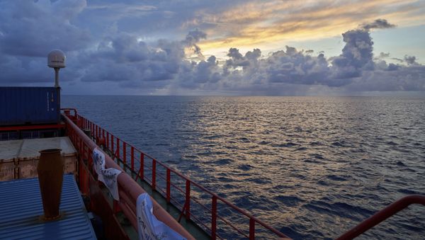 Sun rises near the tiny atoll of Alphonse where scientists began exploring the depths of the Indian Ocean, Thursday March 7, 2019  - Sputnik International
