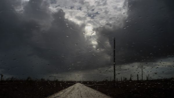 Rain drops cover a car's window shield prior to the arrival of a new tropical depression, that turned into Tropical Storm Humberto, in the aftermath of Hurricane Dorian en route to Mclean's Town, Grand Bahama, Bahamas, Friday Sept. 13, 2019. - Sputnik International