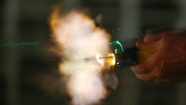 A new non-lethal weapon by BolaWrap, that discharges an 8 foot bola style Kevlar tether at 640 feet per second to entangle a subject at a range of 10-25 feet, is deployed during training in Laguna Niguel, California, U.S., September 5, 2019 - Sputnik International