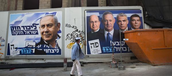 A man walks by election campaign billboards showing Israeli Prime Minister and head of the Likud party Benjamin Netanyahu, left, alongside the Blue and White party leaders, from left to right, Moshe Yaalon, Benny Gantz, Yair Lapid and Gabi Ashkenazi, in Tel Aviv, Israel, Sunday, April 7, 2019. Hebrew on billboards reads, left Strong Likud strong Israel on the right Every vote matters, win Blue and White. (AP Photo/Oded Balilty) A man walks by election campaign billboards showing Israeli Prime Minister and head of the Likud party Benjamin Netanyahu, left, alongside the Blue and White party leaders, from left to right, Moshe Yaalon, Benny Gantz, Yair Lapid and Gabi Ashkenazi, in Tel Aviv, Israel, Sunday, April 7, 2019. Hebrew on billboards reads, left Strong Likud strong Israel on the right Every vote matters, win Blue and White. (AP Photo/Oded Balilty) - Sputnik International