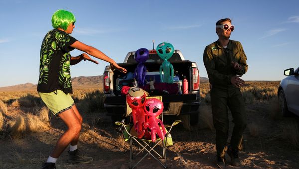 FILE PHOTO: Two men dance on a road to an entrance to Area 51 as an influx of tourists responding to a call to 'storm' Area 51, a secretive U.S. military base believed by UFO enthusiasts to hold government secrets about extra-terrestrials, is expected in Rachel, Nevada, U.S. September 20, 2019. REUTERS/Jim Urquhart/File Photo - Sputnik International