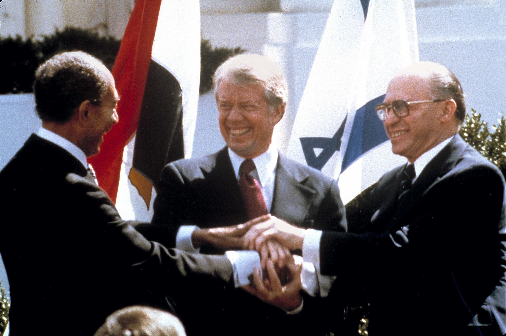 In this file photo taken March 26, 1979, Egyptian President Anwar Sadat,left, U.S. President Jimmy Carter, center, and Israeli Prime Minister Menachem Begin clasp hands on the north lawn of the White House as they completed signing of the peace treaty between Egypt and Israel. When Israeli Prime Minister Menachem Begin shook hands with Egyptian President Anwar Sadat on the White House lawn on March 26, 1979, ordinary Israelis saw not only an end to war with their largest neighbor but also the hope of warm relations with the people next door In this file photo taken March 26, 1979, Egyptian President Anwar Sadat,left, U.S. President Jimmy Carter, center, and Israeli Prime Minister Menachem Begin clasp hands on the north lawn of the White House as they completed signing of the peace treaty between Egypt and Israel. When Israeli Prime Minister Menachem Begin shook hands with Egyptian President Anwar Sadat on the White House lawn on March 26, 1979, ordinary Israelis saw not only an end to war with their largest neighbor but also the hope of warm relations with the people next door - Sputnik International, 1920, 13.10.2023