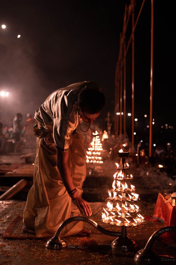 A man leans over to touch a candlestick A man leans over to touch a candlestick - Sputnik International