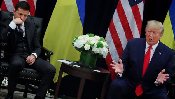 Ukraine's President Volodymyr Zelenskiy listens to U.S. President Donald Trump address reporters during a bilateral meeting on the sidelines of the 74th session of the United Nations General Assembly (UNGA) in New York City - Sputnik International