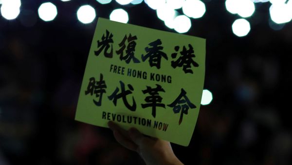 An anti-government protester holds a placard during a rally at Edinburgh Place to show solidarity for arrested political activists being held at San Uk Ling detention centre in Hong Kong, China 27 September 2019. An anti-government protester holds a placard during a rally at Edinburgh Place to show solidarity for arrested political activists being held at San Uk Ling detention centre in Hong Kong, China 27 September 2019. - Sputnik International
